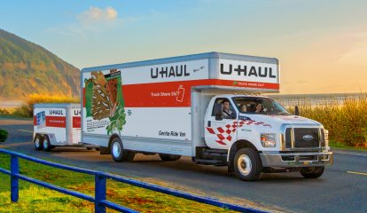 U-Haul Truck towing a trailer on a coastal road